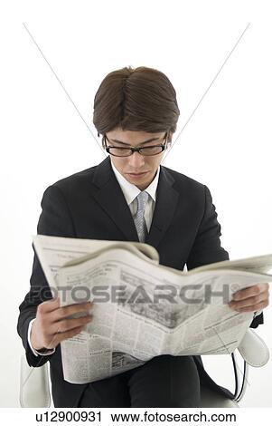 Young businessman reading newspaper View Large Photo Image Stock Image - Young businessman reading newspaper. Fotosearch