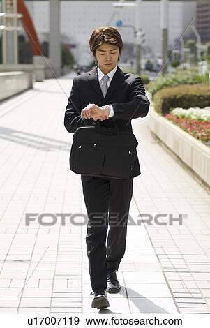 Stock Photo - Young businessman walking. Fotosearch