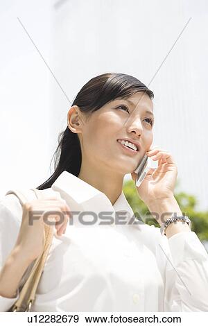 Young woman using mobile phone View Large Photo Image Stock Photo - Young woman using mobile phone. Fotosearch