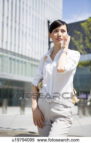 Young woman using mobile phone View Large Photo Image Stock Photography - Young woman using mobile phone. Fotosearch