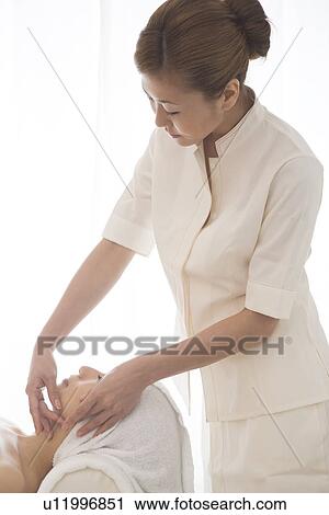 Massage therapist applying facial massage View Large Photo Image Stock Image - Massage therapist applying facial massage. Fotosearch