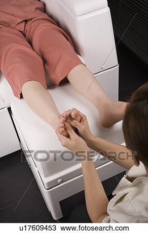 Massage therapist applying foot massage View Large Photo Image Stock Image - Massage therapist applying foot massage. Fotosearch