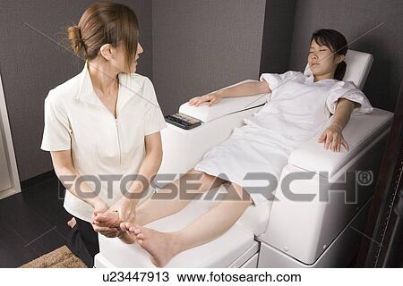 Massage therapist applying foot massage View Large Photo Image Stock Image - Massage therapist applying foot massage. Fotosearch