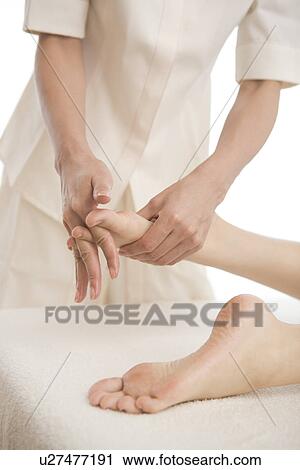 Massage therapist applying foot massage View Large Photo Image Stock Image - Massage therapist applying foot massage. Fotosearch