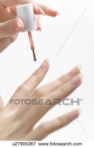 Young woman applying manicure View Large Photo Image Stock Photo - Young woman applying manicure. Fotosearch