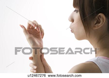 Young woman drying manicure View Large Photo Image Stock Photograph - Young woman drying manicure. Fotosearch