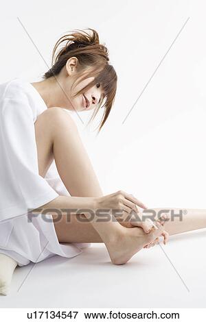 Young woman filing toenails View Large Photo Image Stock Photo - Young woman filing toenails. Fotosearch