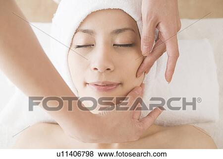 Young woman having facial massage View Large Photo Image Stock Photo - Young woman having facial massage. Fotosearch