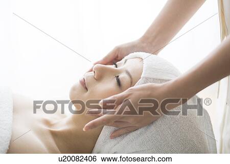 Young woman having facial massage View Large Photo Image Stock Photograph - Young woman having facial massage. Fotosearch