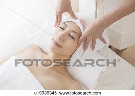 Young woman having head massage View Large Photo Image Stock Photography - Young woman having head massage. Fotosearch