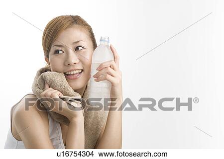 Young woman holding mineral water View Large Photo Image Picture - Young woman holding mineral water. Fotosearch