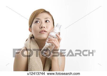 Young woman holding water bottle View Large Photo Image Picture - Young woman holding water bottle. Fotosearch