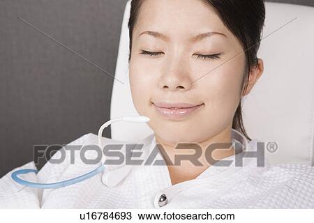 Young woman inhaling oxygen View Large Photo Image Stock Image - Young woman inhaling oxygen. Fotosearch