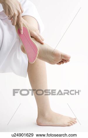 Young woman rubbing foot View Large Photo Image Stock Photo - Young woman rubbing foot. Fotosearch
