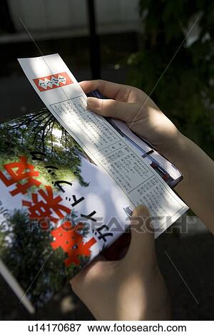 Hands of a woman holding paper fortune View Large Photo Image Stock Photo - Hands of a woman holding paper fortune. Fotosearch