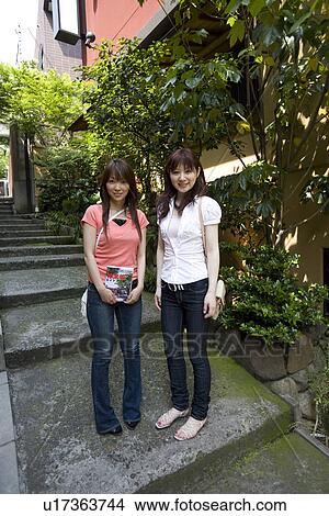 Picture - Portrait of two women standing. Fotosearch