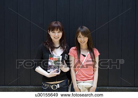 Stock Photo - Portrait of two women standing. Fotosearch