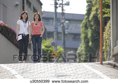 Stock Photo - Portrait of two women standing. Fotosearch