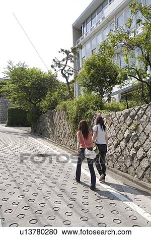 Stock Image - Two women walking in Kagurazaka, Tokyo, Japan. Fotosearch