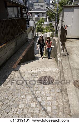 Stock Image - Two women walking in Kagurazaka, Tokyo, Japan. Fotosearch