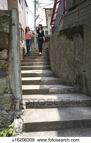 Stock Photo - Two women walking in Kagurazaka, Tokyo, Japan. Fotosearch