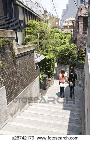 Stock Photo - Two women walking in Kagurazaka, Tokyo, Japan. Fotosearch