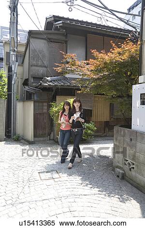 Stock Photography - Two women walking in Kagurazaka, Tokyo, Japan. Fotosearch