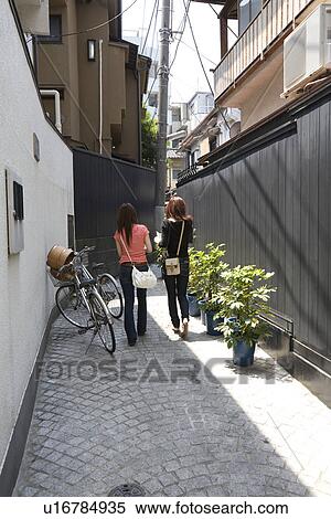 Stock Photography - Two women walking in Kagurazaka, Tokyo, Japan. Fotosearch