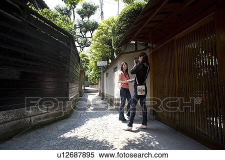 Young woman taking photograph View Large Photo Image Stock Photography - Young woman taking photograph. Fotosearch