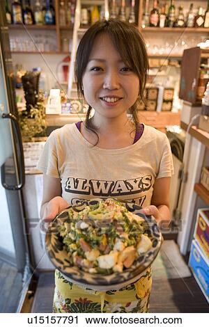 Stock Image - Waitress serving food. Fotosearch
