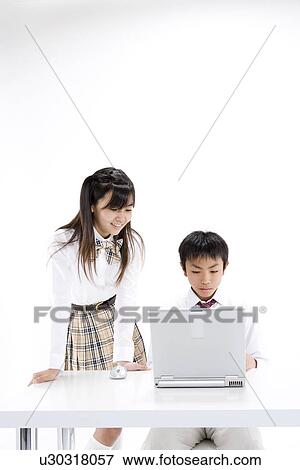 Middle school students using computer View Large Photo Image Stock Photo - Middle school students using computer. Fotosearch