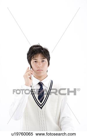 Stock Photography - Teenage boy calling with mobile phone. Fotosearch
