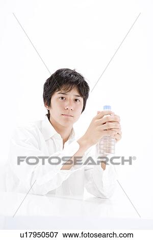 Stock Photo - Teenage boy holding water bottle. Fotosearch