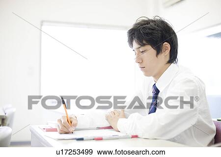 Stock Photo - Teenage boy studying. Fotosearch