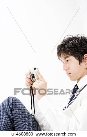 Teenage boy taking photograph View Large Photo Image Stock Image - Teenage boy taking photograph. Fotosearch