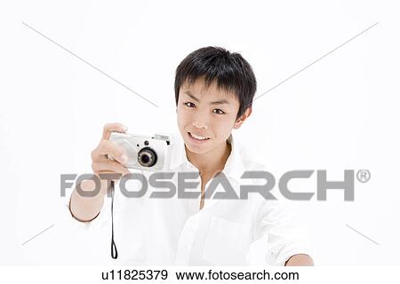 Teenage boy taking photograph View Large Photo Image Stock Photo - Teenage boy taking photograph. Fotosearch
