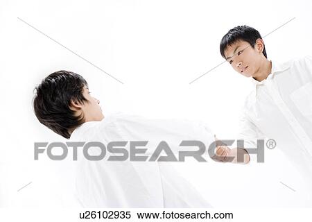 Teenage boys shaking hands View Large Photo Image Stock Photography - Teenage boys shaking hands. Fotosearch