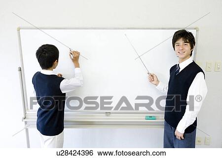 Stock Photograph - Teenage boys standing in front of white board. Fotosearch