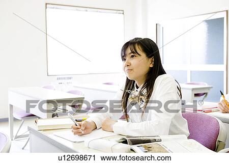 Stock Image - Teenage girl studying. Fotosearch
