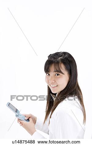 Stock Photo - Teenage girl using mobile phone. Fotosearch