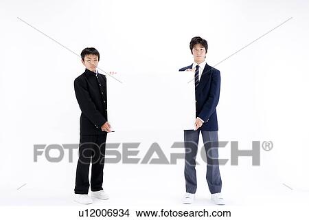 Picture - Two teenage boys holding blank message board. Fotosearch