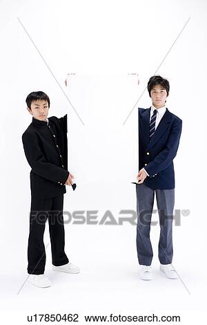 Two teenage boys holding blank message board View Large Photo Image Stock Image - Two teenage boys holding blank message board. Fotosearch