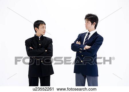 Stock Image - Two teenage boys looking each other. Fotosearch