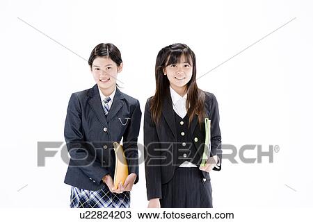 Stock Image - Two teenage girls standing. Fotosearch