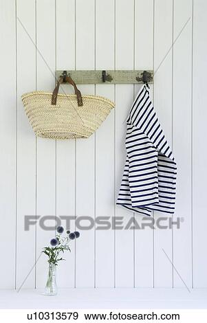 Bag and shirts hanging on wall View Large Photo Image Stock Photo - Bag and shirts hanging on wall. Fotosearch
