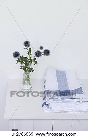 Stock Photo - Flower in vase and kitchen clothes. Fotosearch