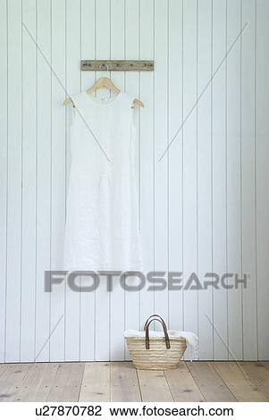 Linen dress hanging on wall View Large Photo Image Stock Image - Linen dress hanging on wall. Fotosearch