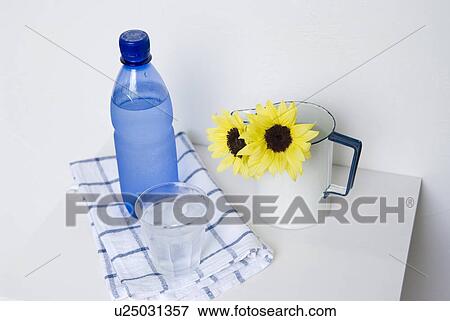 Mineral water and a glass of water View Large Photo Image Stock Photo - Mineral water and a glass of water. Fotosearch