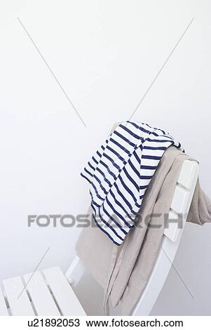 Stock Image - Shirt and pants on chair. Fotosearch