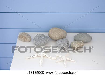 Stock Image - Starfish and rocks. Fotosearch